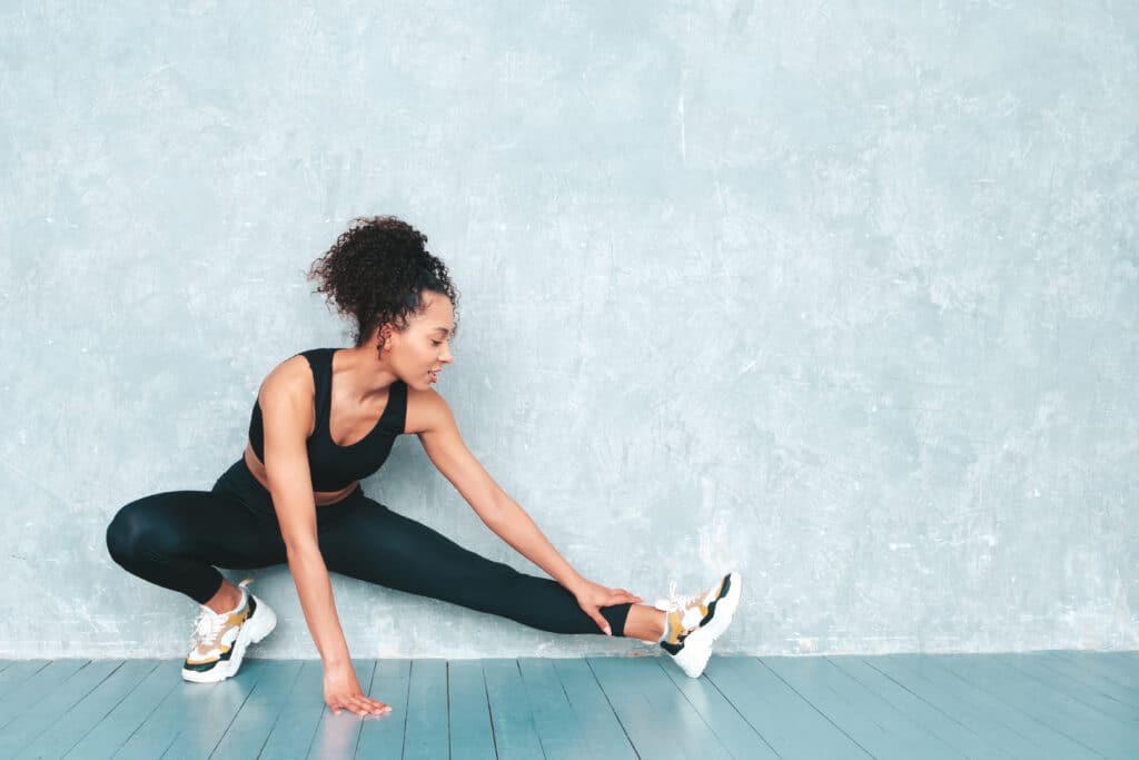Woman stretching in workout clothes.